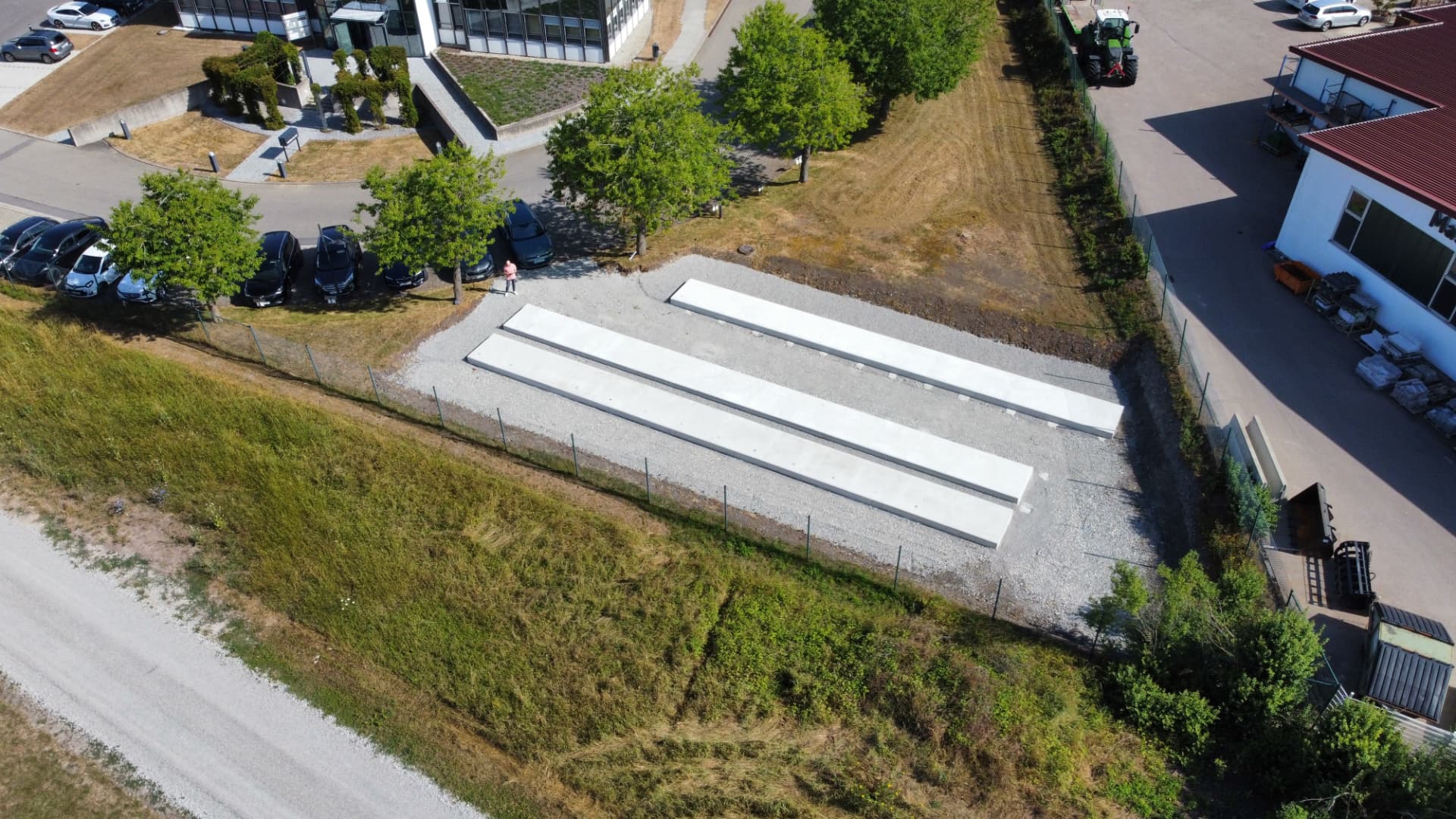 Luftbild: fertige Fundamente und eingezäuntes Grundstück im Gewerbegebiet